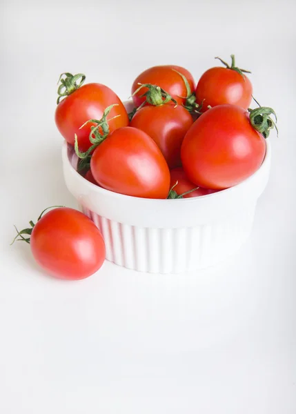 Сherry tomatoes in a bowl  on white background Stock Photo