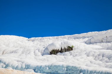 Pamukkale. Close up of texture of travertine over blue sky. Turkey.