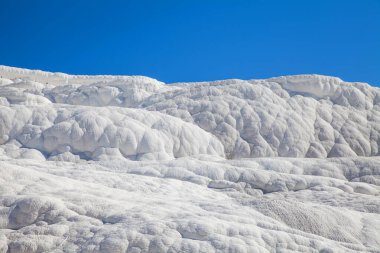 Pamukkale. Close up of texture of travertine over blue sky. Turkey.