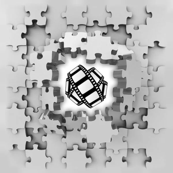 Grey puzzle jigsaw with movie tape revelation — Stock Photo, Image