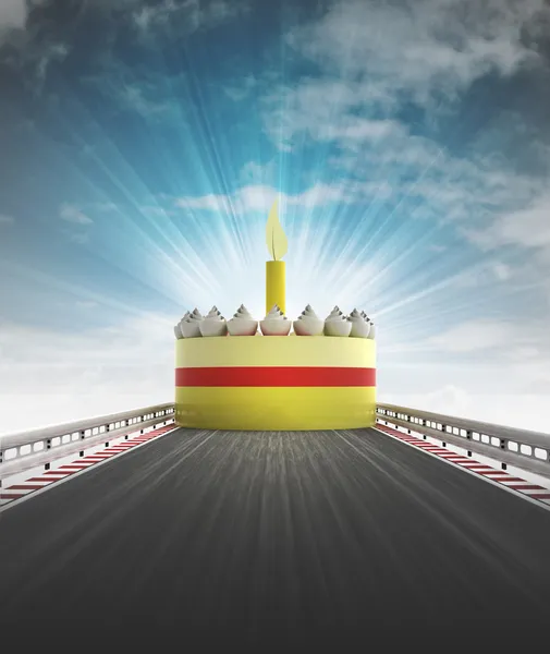 Cake on motorway leading to celebration with sky flare — Stock Photo, Image