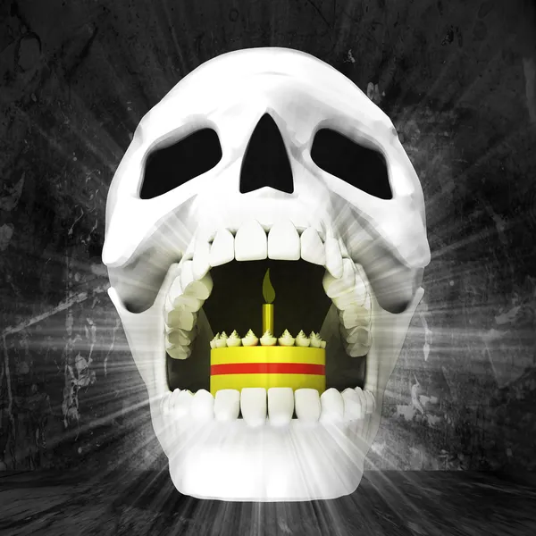 Human skull with cake in jaws — Stock Photo, Image