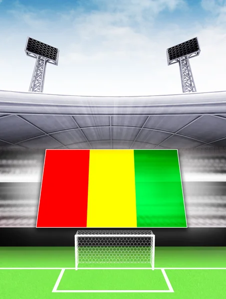 Guinean lippu lippu moderni jalkapallostadion — kuvapankkivalokuva