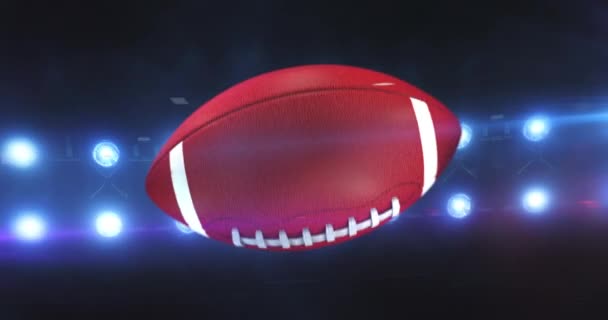 Летит Американский Футбольный Мяч Мигающими Прожекторами Стадиона Ночью Вращающийся Спортивный — стоковое видео