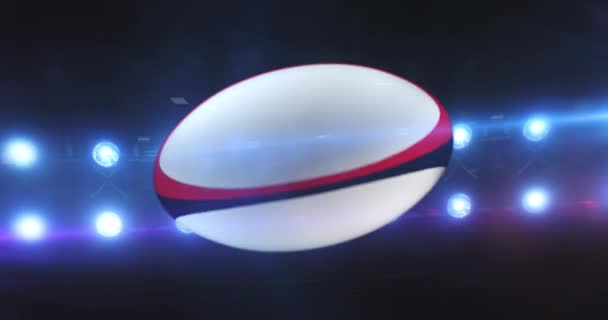 Летающий Регбийный Мяч Мигающими Прожекторами Стадиона Ночью Вращающийся Спортивный Мяч — стоковое видео