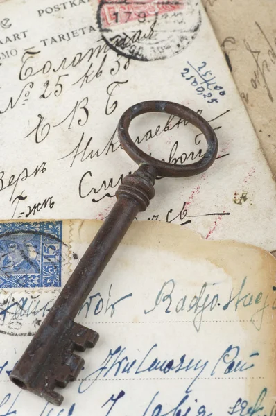 Old key with postcards — Stock Photo, Image