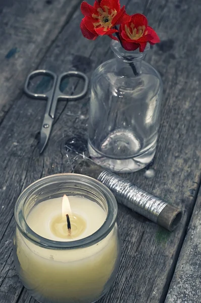 Flower,threads and burning candle — Stock Photo, Image