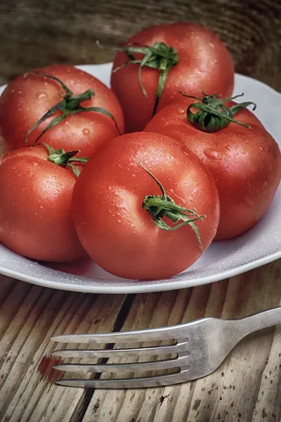 Tomatoes on the background of wood — Stock Photo, Image