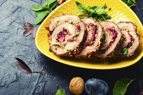 Slice meatloaf baked with autumn plum and nuts.Festive meat roll