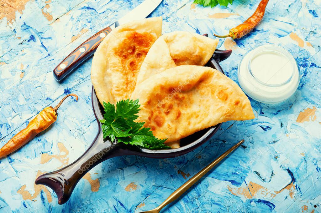Chebureks, fried crescent-shaped cakes with meat filling
