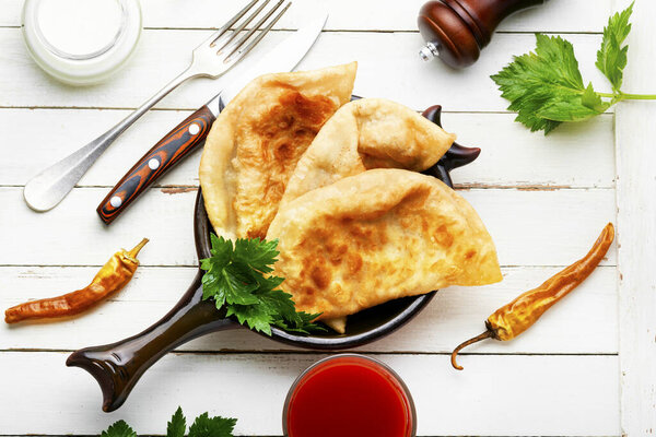 Chebureks, fried crescent-shaped cakes with meat filling. Crimean Tatar cuisine