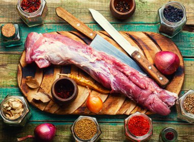 Appetizing raw pork meat for cooking. Raw meat tenderloin on cutting board
