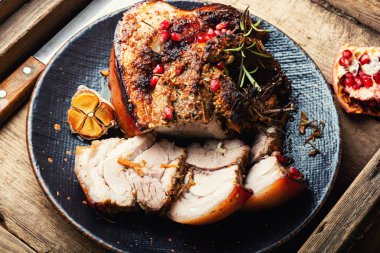 Roasted meat with herbs and spices on an old vintage table