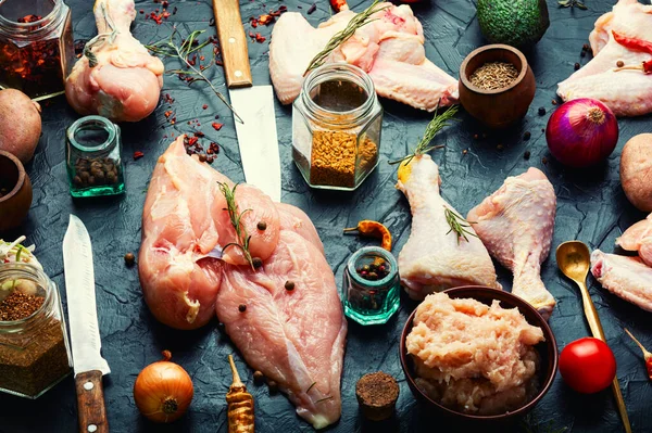 Pieces of raw chicken meat, fillet, wings, chicken legs and minced meat. Set chicken meat on kitchen table