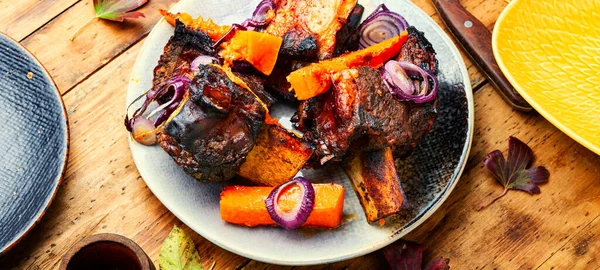 Grilled beef ribs with pumpkin.Roasted beef ribs on bone