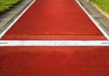 Long jump spring plank in an outdoor stadium clipart