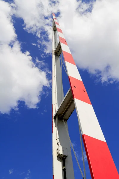 Red and white raised barrier — Stock Photo, Image