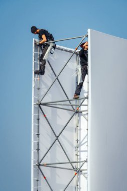 Scaffolders climbing on scaffolding working clipart