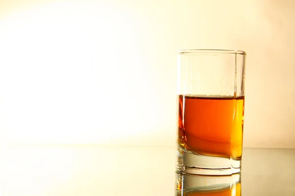 Glass of liquor on brown gradient background — Stock Photo, Image