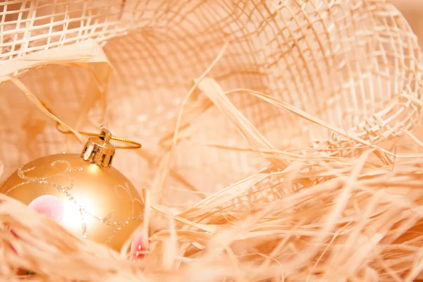 Christmas background with boll and straw in gold — Stock Photo, Image