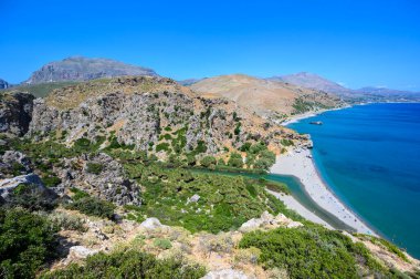 Preveli Sahili - güzel nehriyle ünlüdür açık mavi su ve plajın arkasındaki tropikal palmiye ormanıyla - güney Girit adasında, Yunanistan, Avrupa.