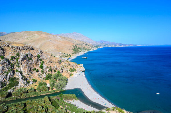 Preveli Beach - famous for the beautiful river with azure clear water and tropical palm forest behind the beach  - in southern Crete island, Greece, Europe.