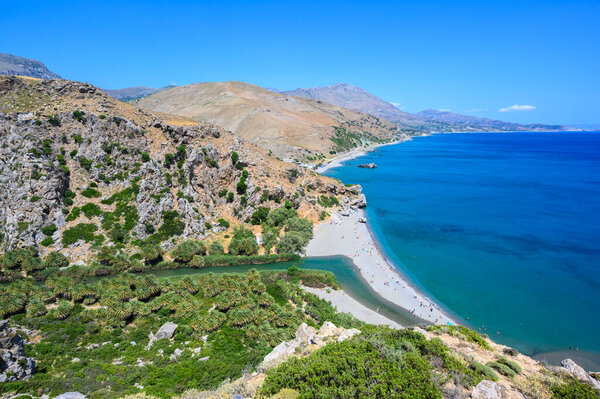 Preveli Beach - famous for the beautiful river with azure clear water and tropical palm forest behind the beach  - in southern Crete island, Greece, Europe.