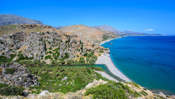 Preveli Beach - famous for the beautiful river with azure clear water and tropical palm forest behind the beach  - in southern Crete island, Greece, Europe.