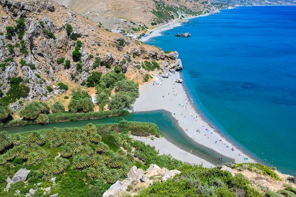 Preveli Beach - famous for the beautiful river with azure clear water and tropical palm forest behind the beach  - in southern Crete island, Greece, Europe.