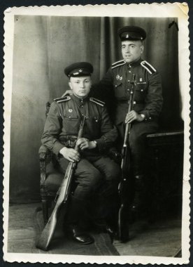 USSR - CIRCA 1950: Photo taken in the USSR, depicted two soldiers of the Red Army with weapons in hand, circa 1950 clipart