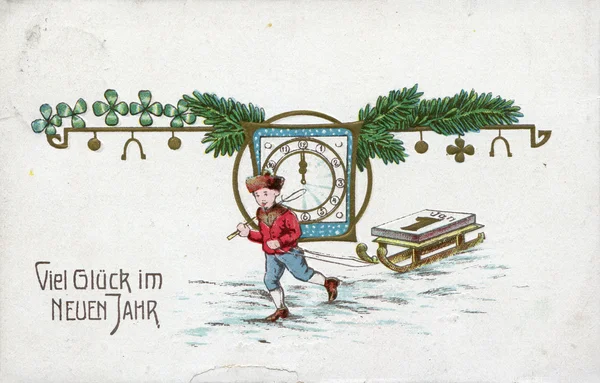 German New Year greeting postcard "Many Happy New Year!", depicts a boy with sleds, watches and spruce branches, circa 1910 — Stock Photo, Image