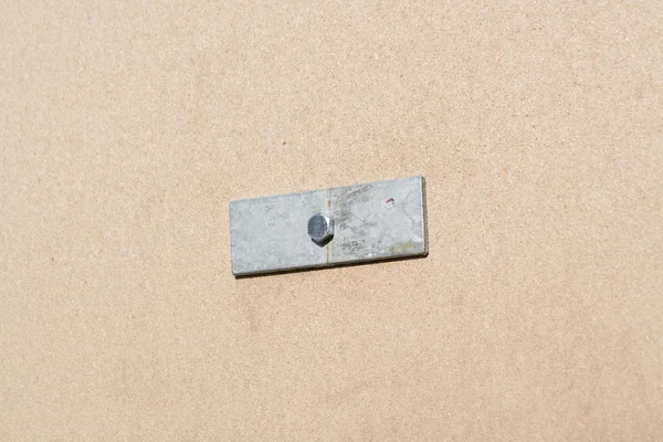 Metal bracket on the Medium-density fibreboard — Stock Photo, Image