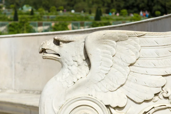 A fragment of the bench. Marble head of a griffin. Sanssouci. Podsdam. Germany — Stock Photo, Image