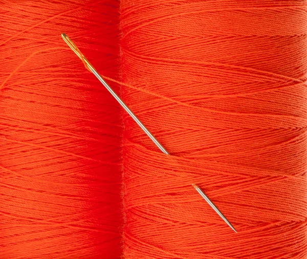 Orange thread with needle — Stock Photo, Image