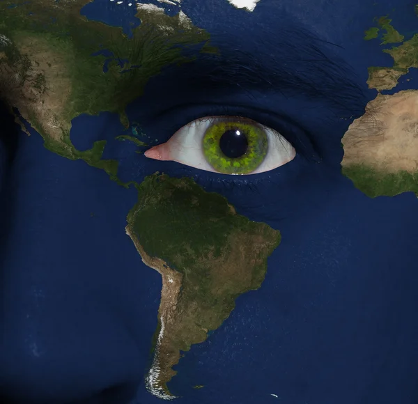 Earth painted on face with green eye — Stock Photo, Image