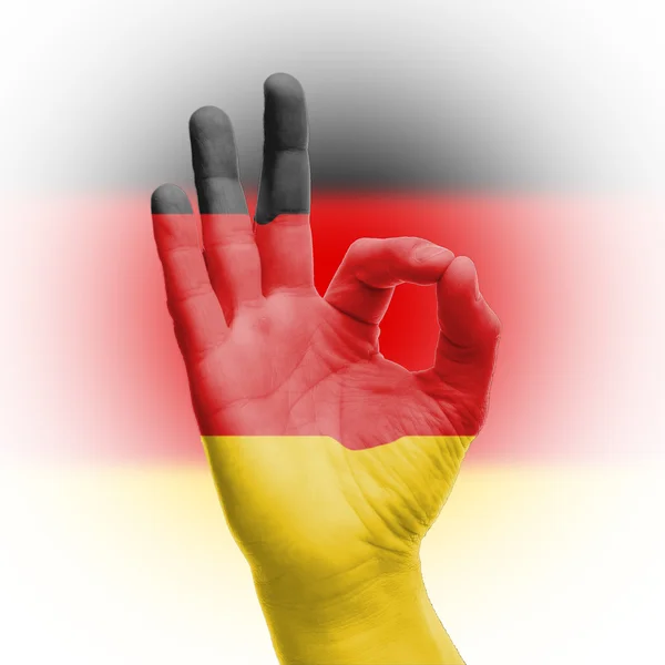 Рука Ok знак з німецький прапор — стокове фото