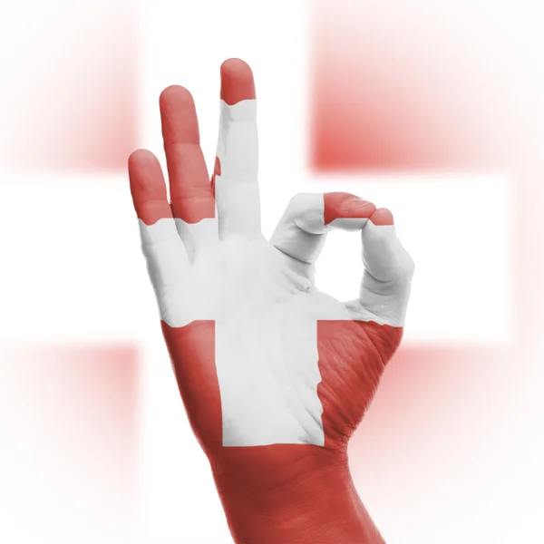 Hand OK sign with Swiss flag — Stock Photo, Image