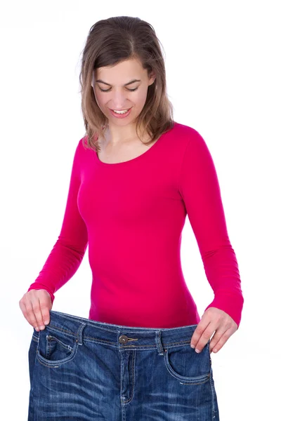 Woman showing how much weight she lost. Healthy lifestyles conce — Stock Photo, Image