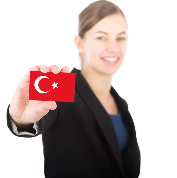 Business woman holding a card with the Turkish flag — Stock Photo, Image