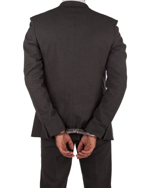 Businessman in suit and handcuffs — Stock Photo, Image