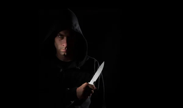 Dangerous hooded man holding knife — Stock Photo, Image