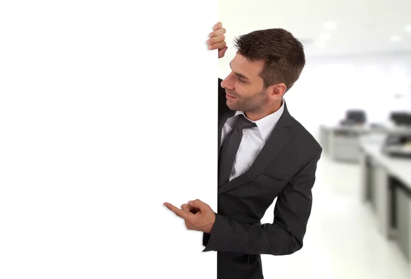 Businessman pointing at a blank board — Stock Photo, Image