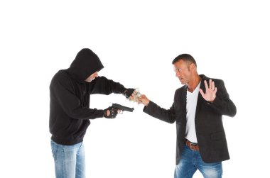 Robber with gun grabbing money from victim clipart