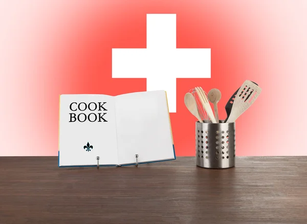 Cookbook and kitchen utensils with Swiss flag — Stock Photo, Image