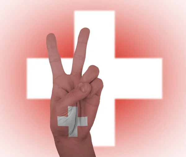 Hand peace sign with flag of Switzerland — Stock Photo, Image