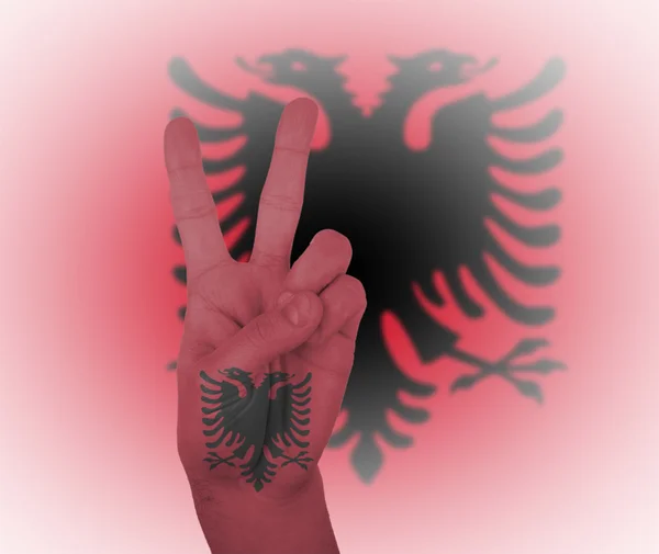 Hand peace sign with flag of Albania