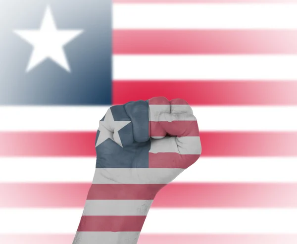 Fist wrapped in the flag of Liberia — Stock Photo, Image