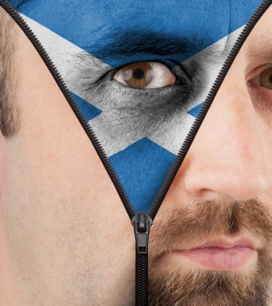 Unzipping face to flag of Scotland — Stock Photo, Image