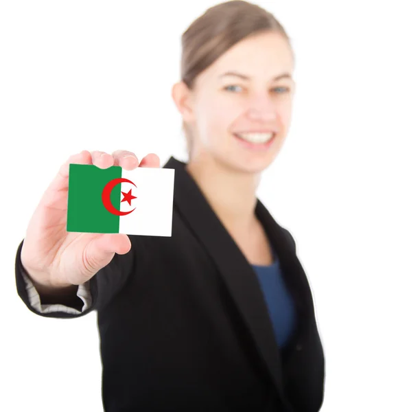 Business woman holding a card with the flag of Algeria — Stock Photo, Image