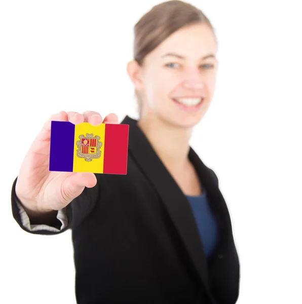 Business woman holding a card with the flag of Andorra — Stock Photo, Image